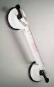 At each end of the productâ€™s cylindrical â€˜grabâ€™ portion is a round attachment with suction cup on the bottom and handle on the top that, when pulled, anchors cup to smooth surface.