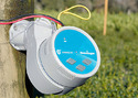 Photo of white irrigation controller box with bue face mounted on fence post