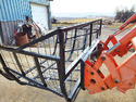 Tractor front-loader with a Homemade Loader Firewood Basket mounted to it
