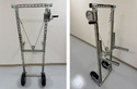2 pics of a DIY Unistrut Hive Lifter that looks like a metal frame with 2 wheels at the bottom and a hand winch that lifts 2 metal arms on the frame.